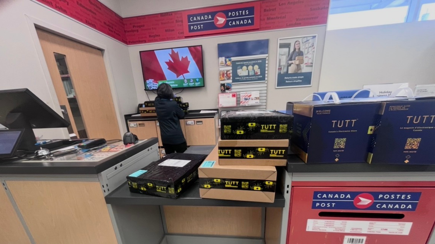 TUTT™ product boxes ready for shipping at a Canada Post office, showcasing trusted Canadian electronics delivery.
