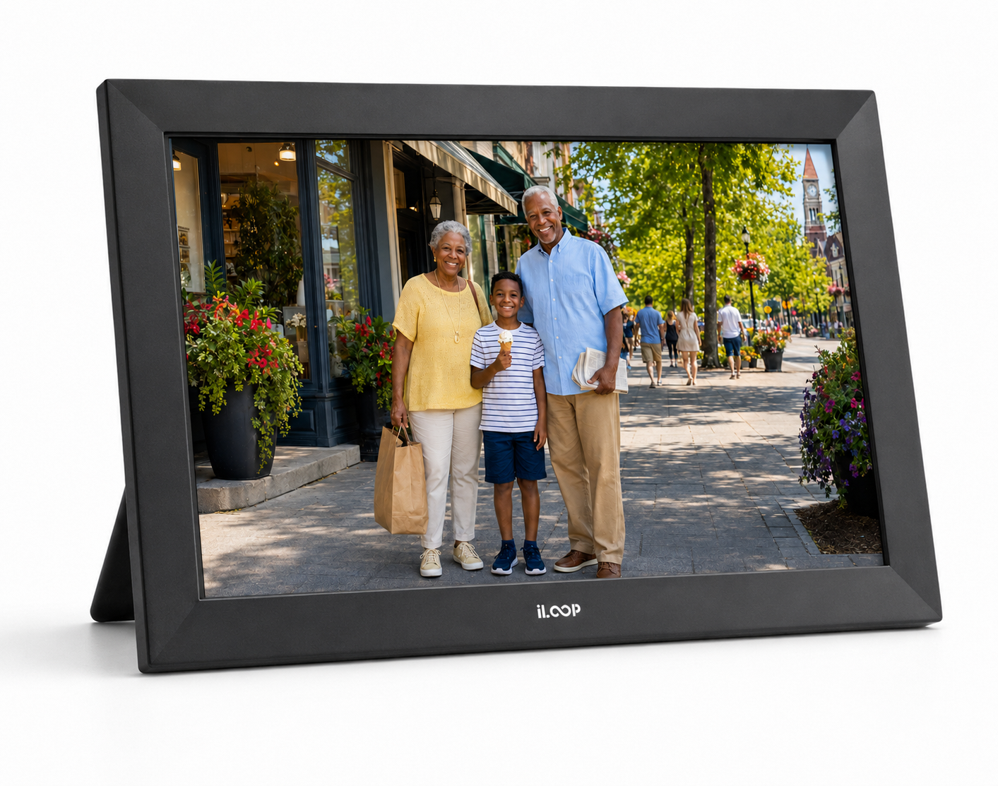 A black digital picture frame with a stand, displaying a photo of a grandfather, grandmother, and child on a city sidewalk. The brand name 'iLOOP' is visible at the bottom center of the frame.