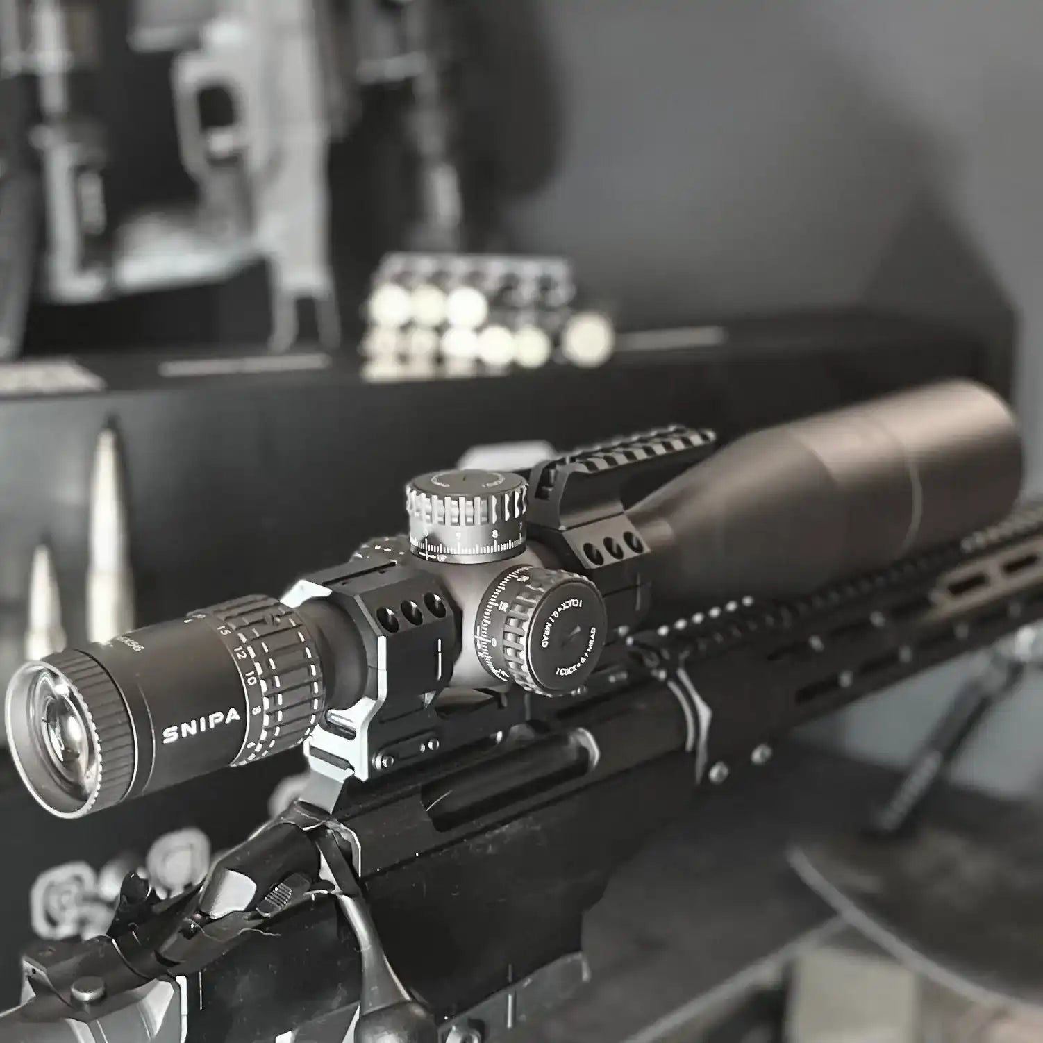 SNIPA tactical rifle scope with MRAD reticle and mount on rifle in dark indoor setting TUTT