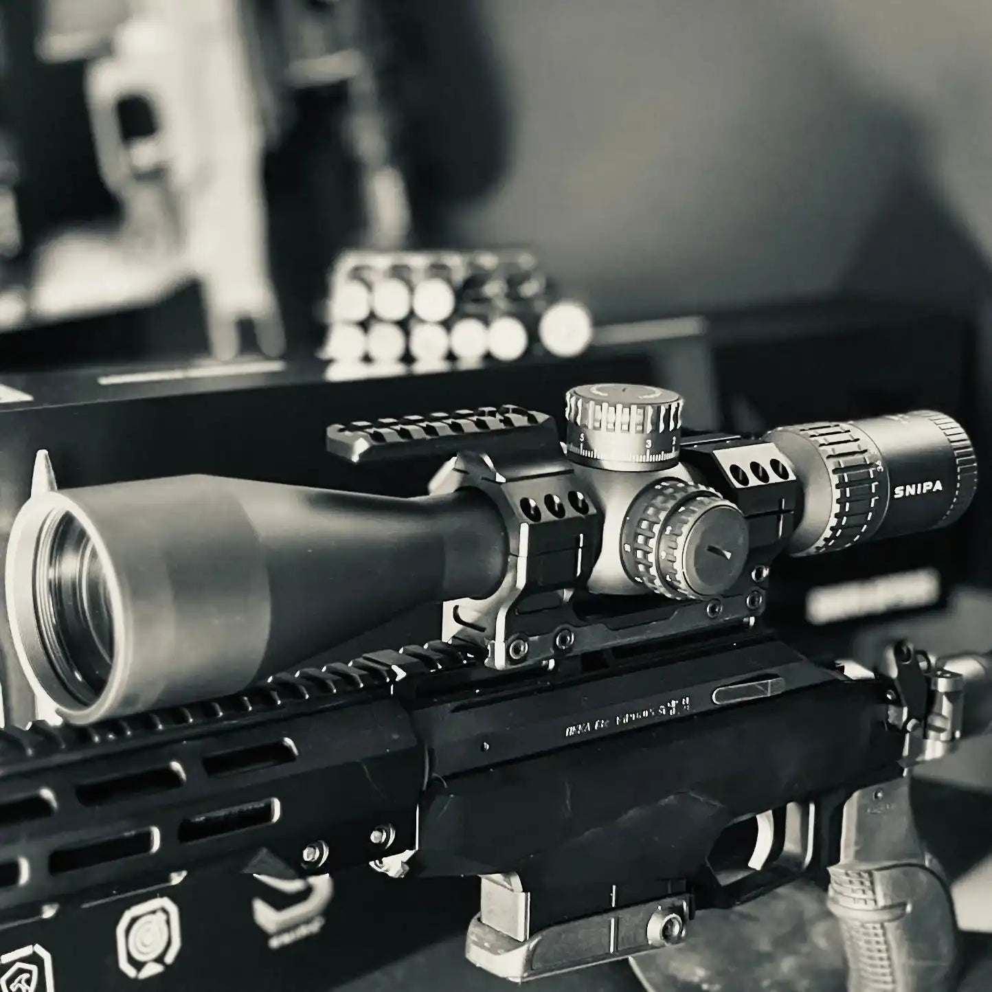 Tactical SNIPA Wolf Ice rifle scope with mount and adjustment knobs on a modern rifle, TUTT