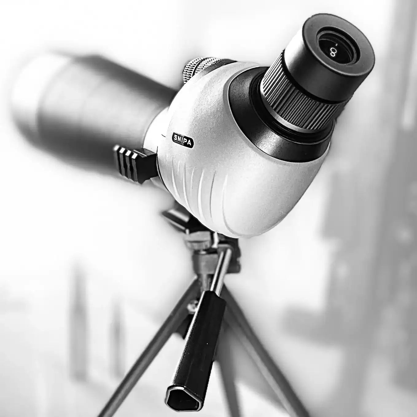 SNIPA spotting scope with tripod, black and silver body, closeup side view. TUTT