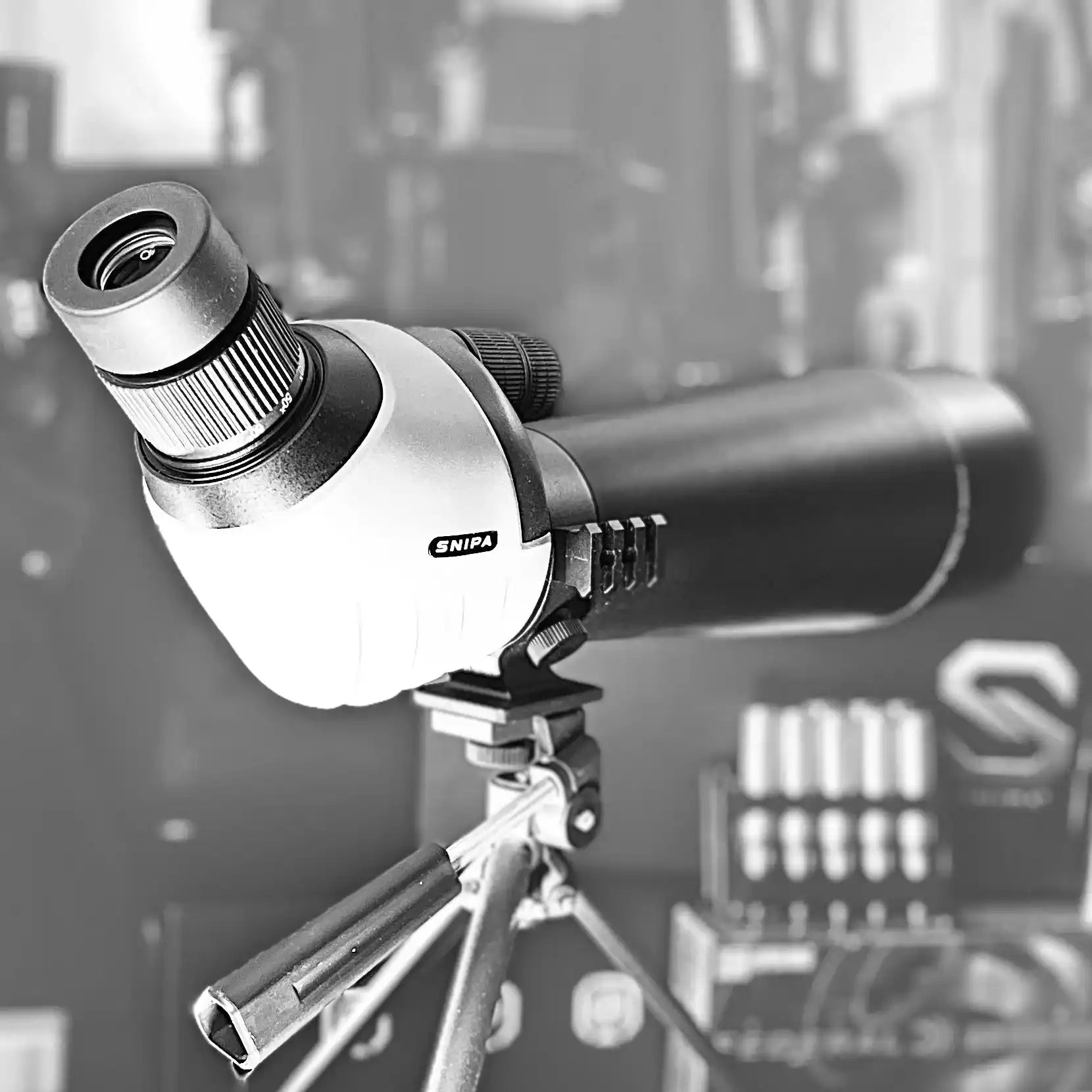 SNIPA spotting scope on tripod with focus dial, tactical shooting gear setup. TUTT