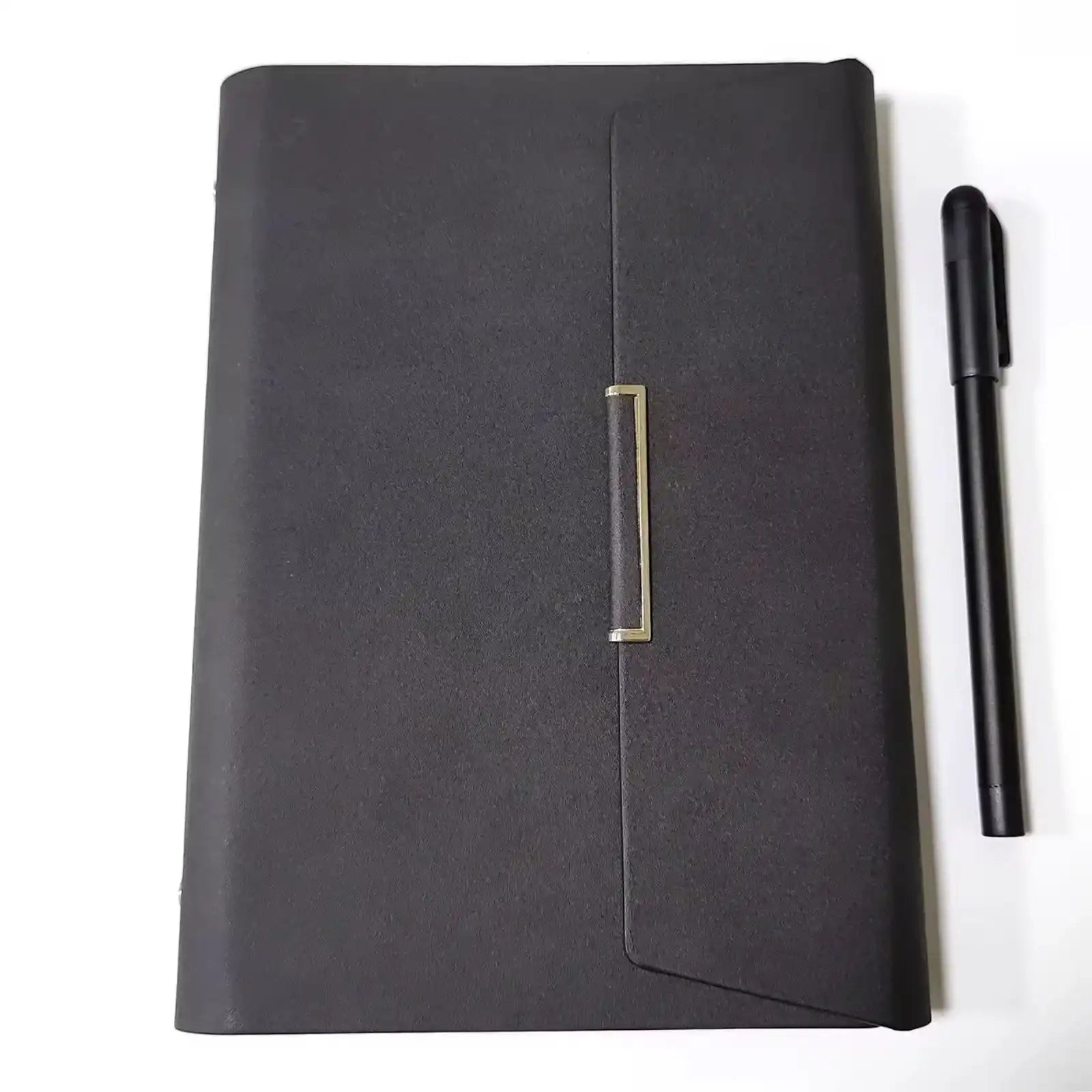 Closed black leather notebook with gold clasp and black pen on white background TUTT