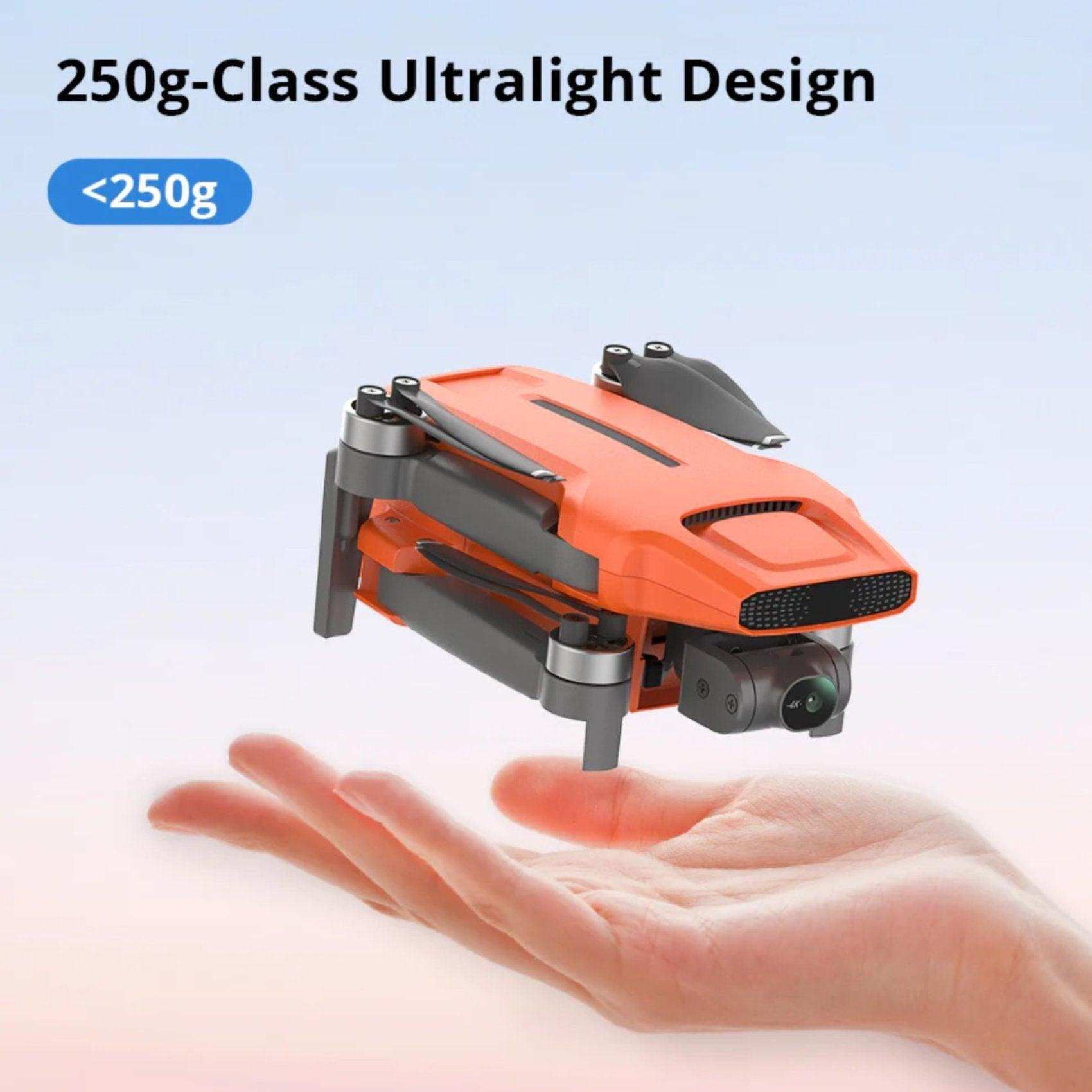 Folded orange ultralight GPS drone with 4K camera displayed above an open hand, 250g class. TUTT