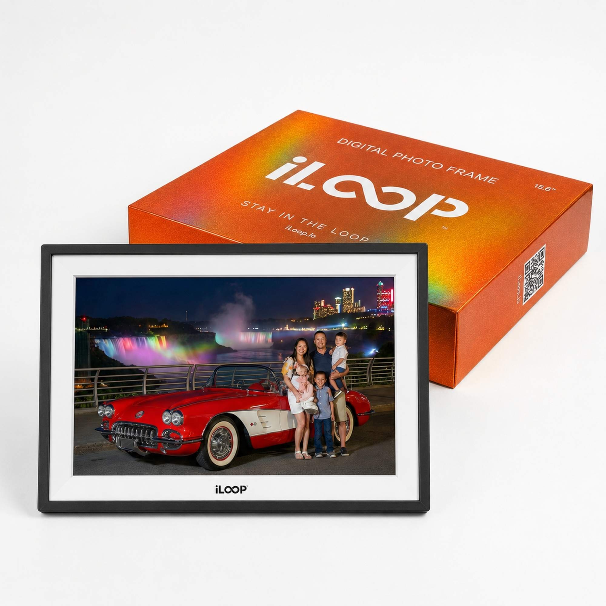 An iLOOP digital photo frame with a black bezel and white mat, displaying a colorful family portrait, shown in front of its orange product packaging box on a clean white background.