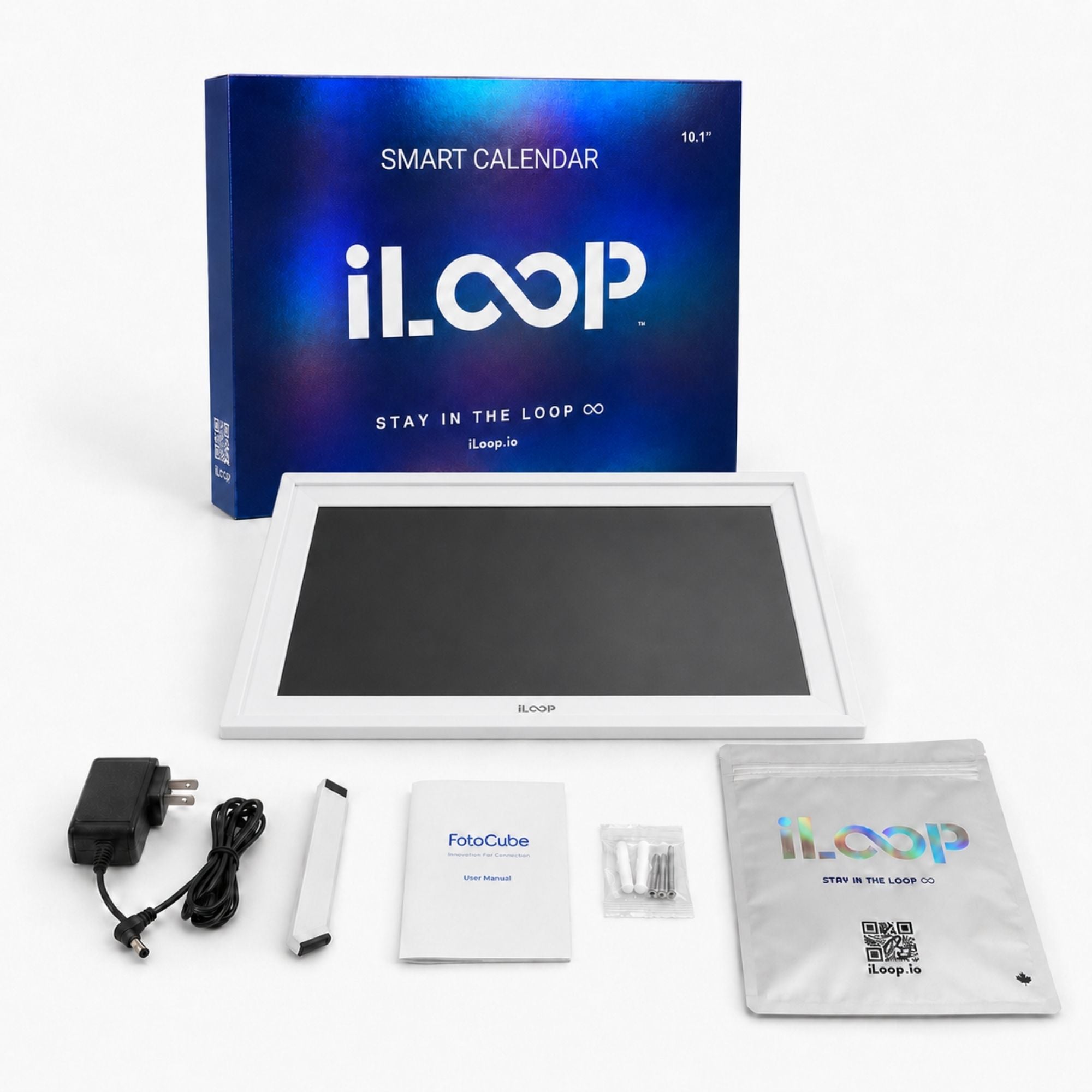 iLoop smart calendar display kit with a 10.1" screen, blue retail box, power adapter, cable, instruction booklet, small accessories, and a storage pouch on a white background.