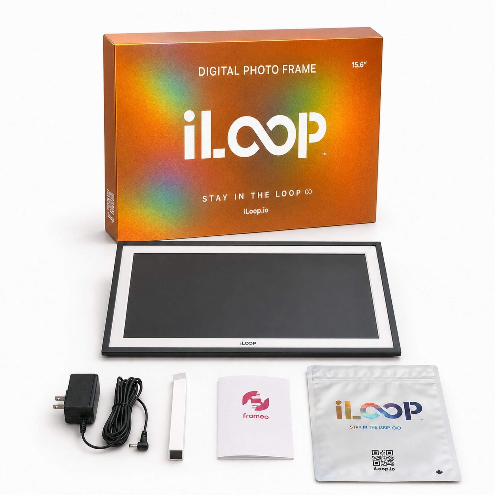 iLoop digital photo frame 15.6 inch with its orange packaging box, power adapter, cable, instruction booklet, and cleaning cloth on a white background.