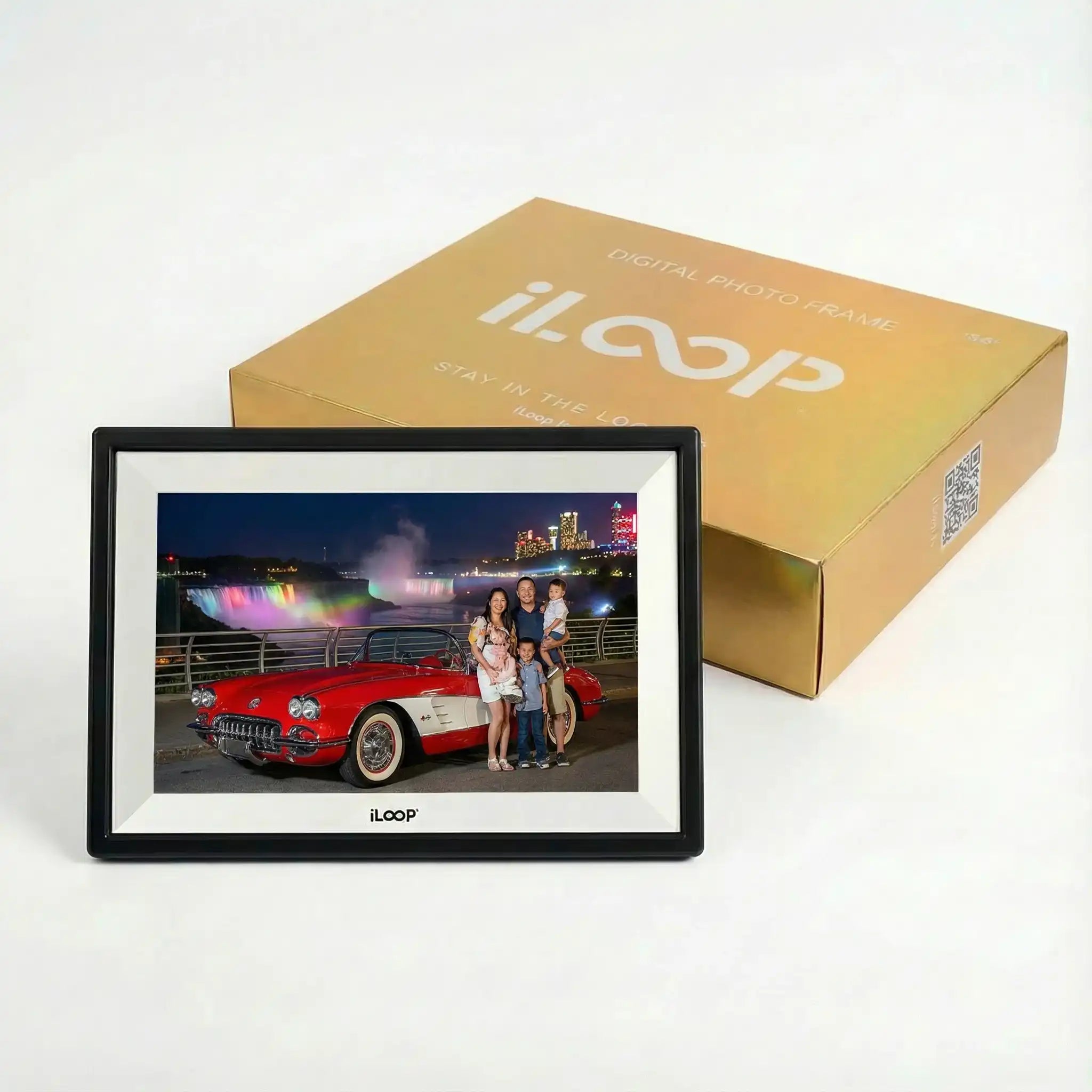 Black digital photo frame displaying a family photo, set in front of a gold product box, TUTT