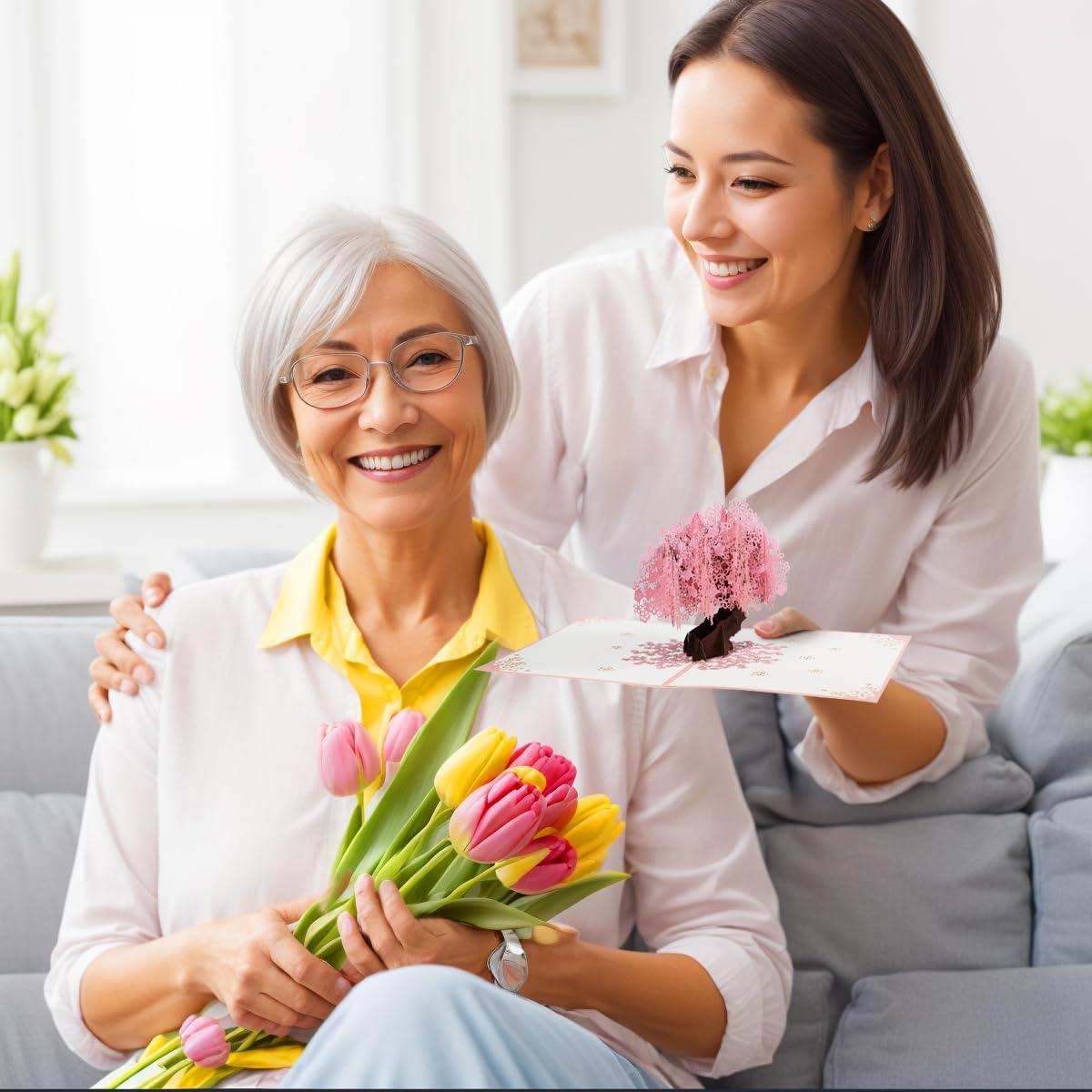Woman gives smiling older lady tulips and a pop-up birthday greeting card with envelope, TUTT