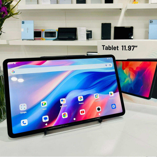 11.97-inch Android tablet with colorful display, dual camera, and app icons on white table, TUTT