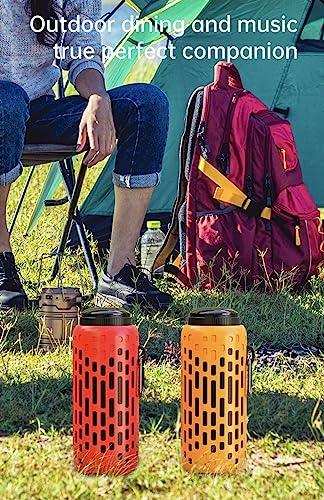 Outdoor scene with two portable waterproof mini speakers, red and orange, with hook and LED lighting on grass near a tent, backpack, and person sitting. TUTT