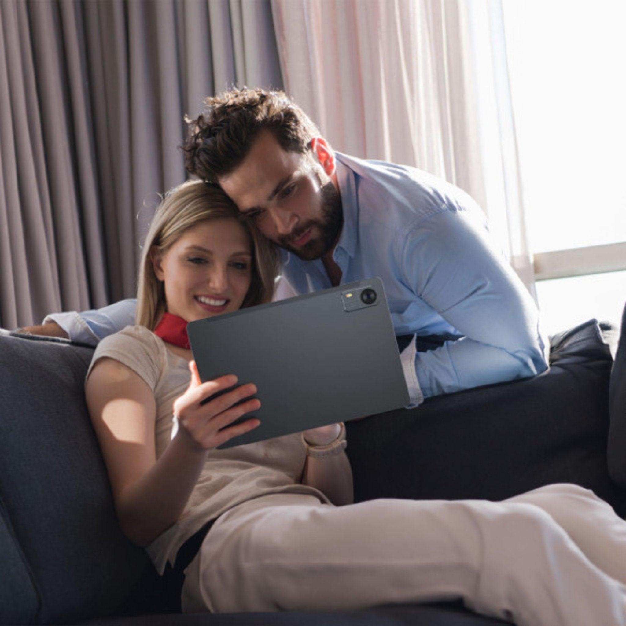 Couple relaxing on sofa using TUTT 2-in-1 Pro 101 tablet with rear camera TUTT