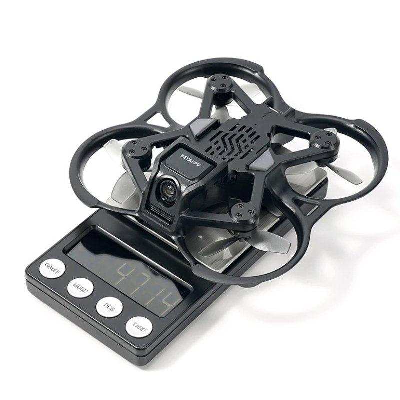 BETAFPV brushless quadcopter drone on digital scale displaying weight, close-up view TUTT