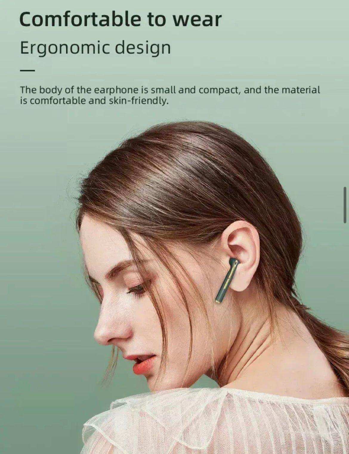Woman wearing classic wireless earbuds with ergonomic design on green background, TUTT