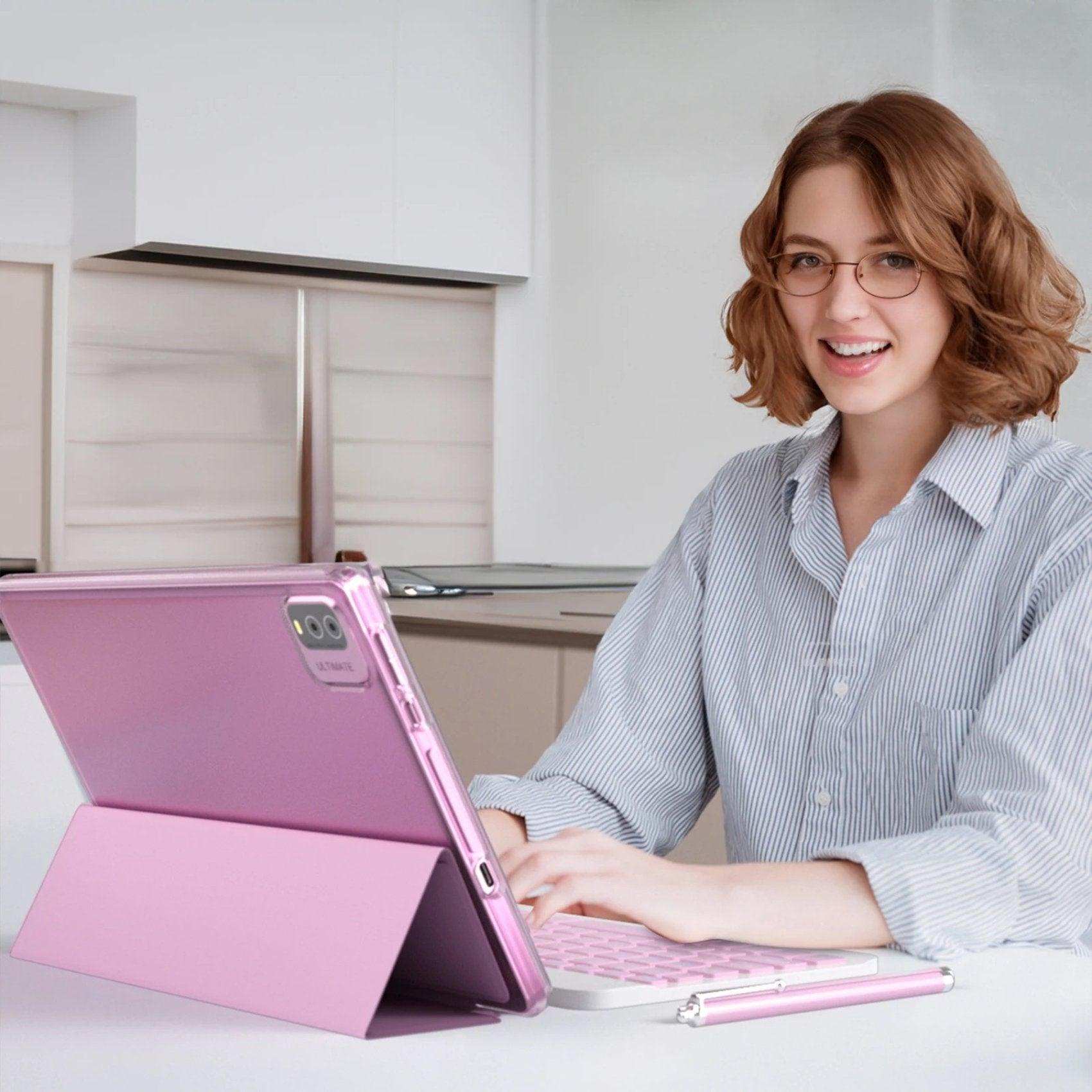 Woman using pink 2-in-1 10.1-inch Android tablet with keyboard and stylus in modern kitchen, TUTT
