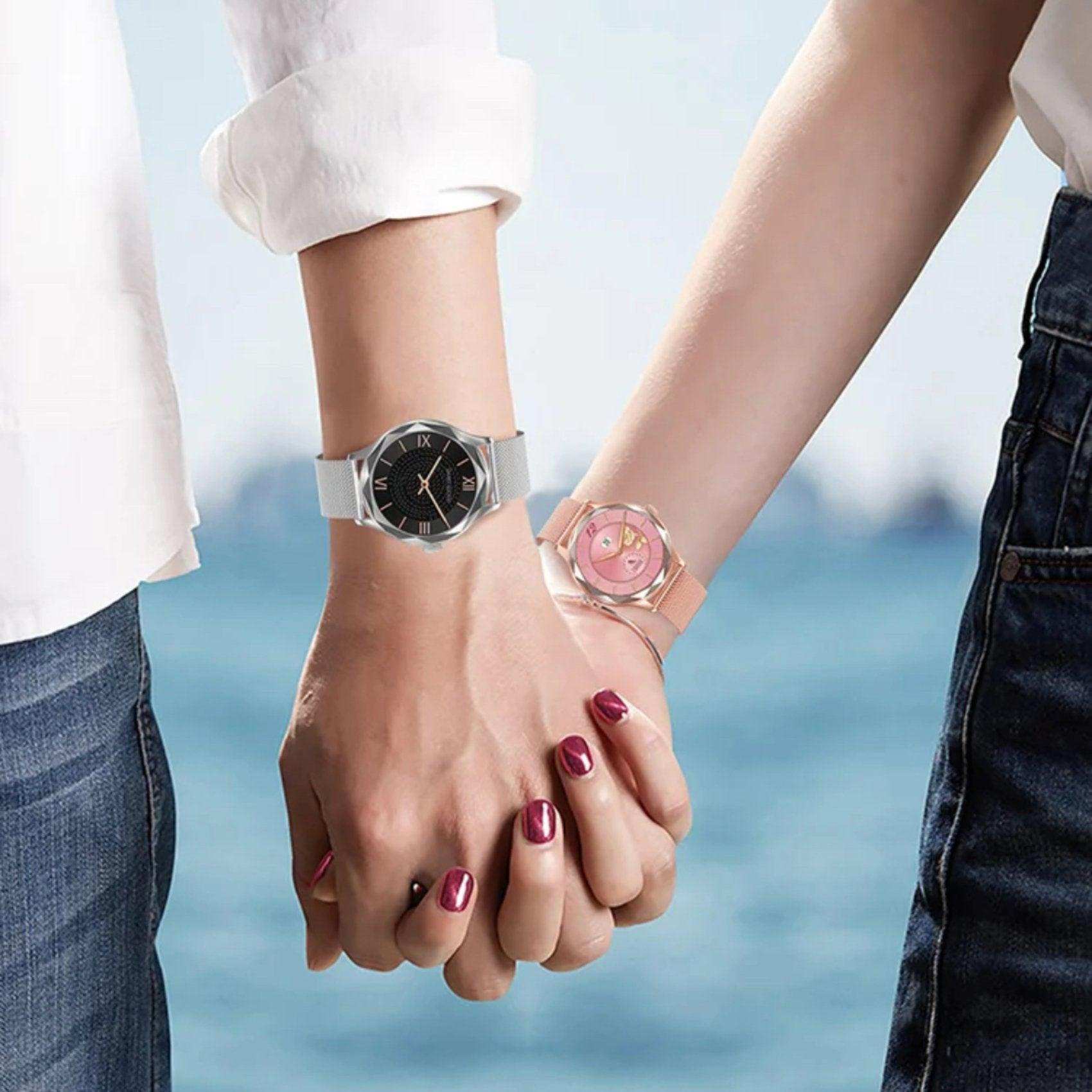 Couple holding hands by the sea wearing diamond AMOLED screen smartwatches with steel straps TUTT