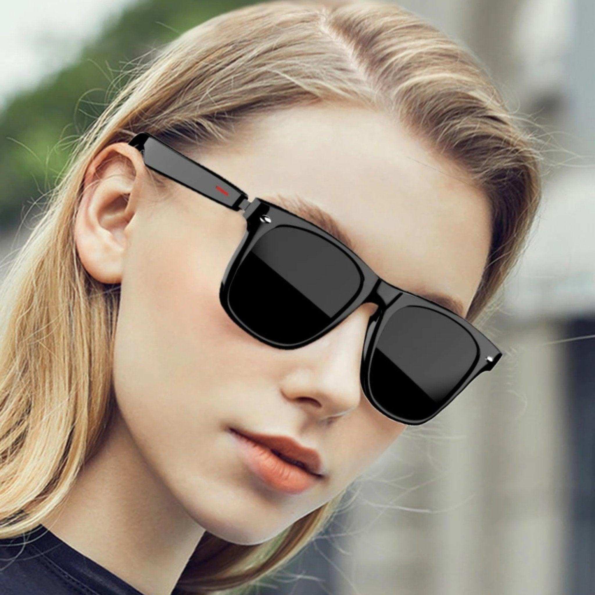 Woman wearing TUTT E13 Bluetooth smart sunglasses with black TR90 frame outdoors, TUTT