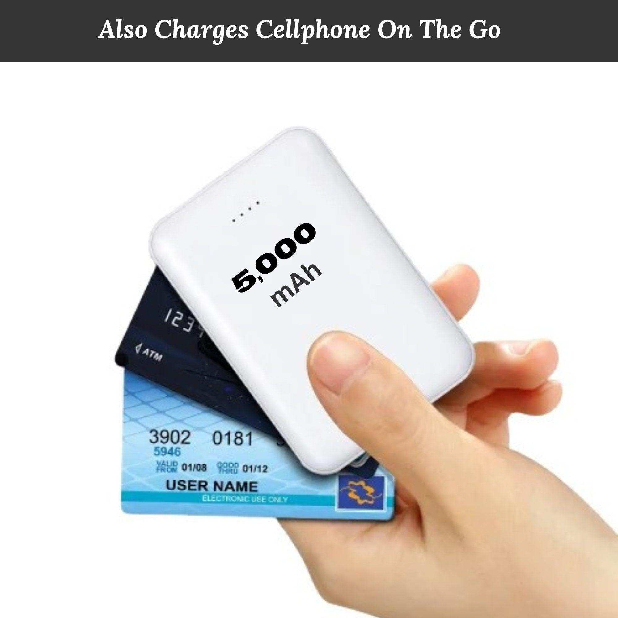 Hand holding compact 5000mAh power bank and credit cards, portable charger for mobile devices TUTT