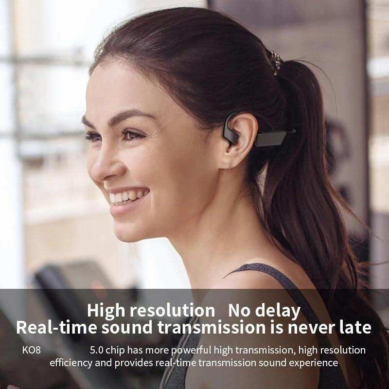Smiling woman wearing K08 bone conduction wireless headphones at the gym, TUTT