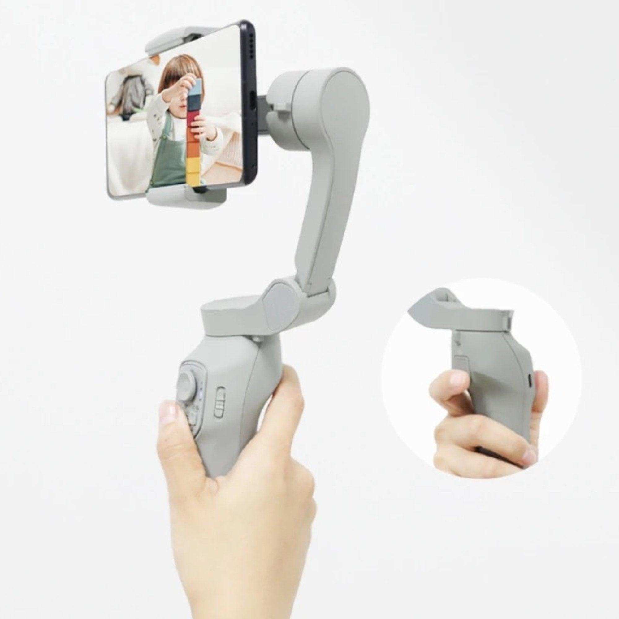 Hand holding 3-axis smartphone gimbal stabilizer with phone and face tracking module, TUTT
