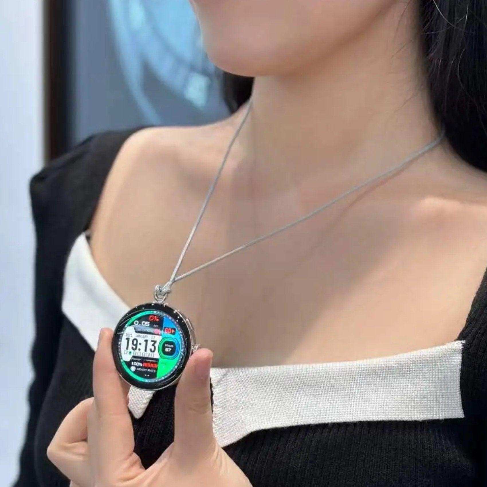 Woman wearing TUTT LA9 AMOLED smart watch as a pendant necklace, digital display visible TUTT