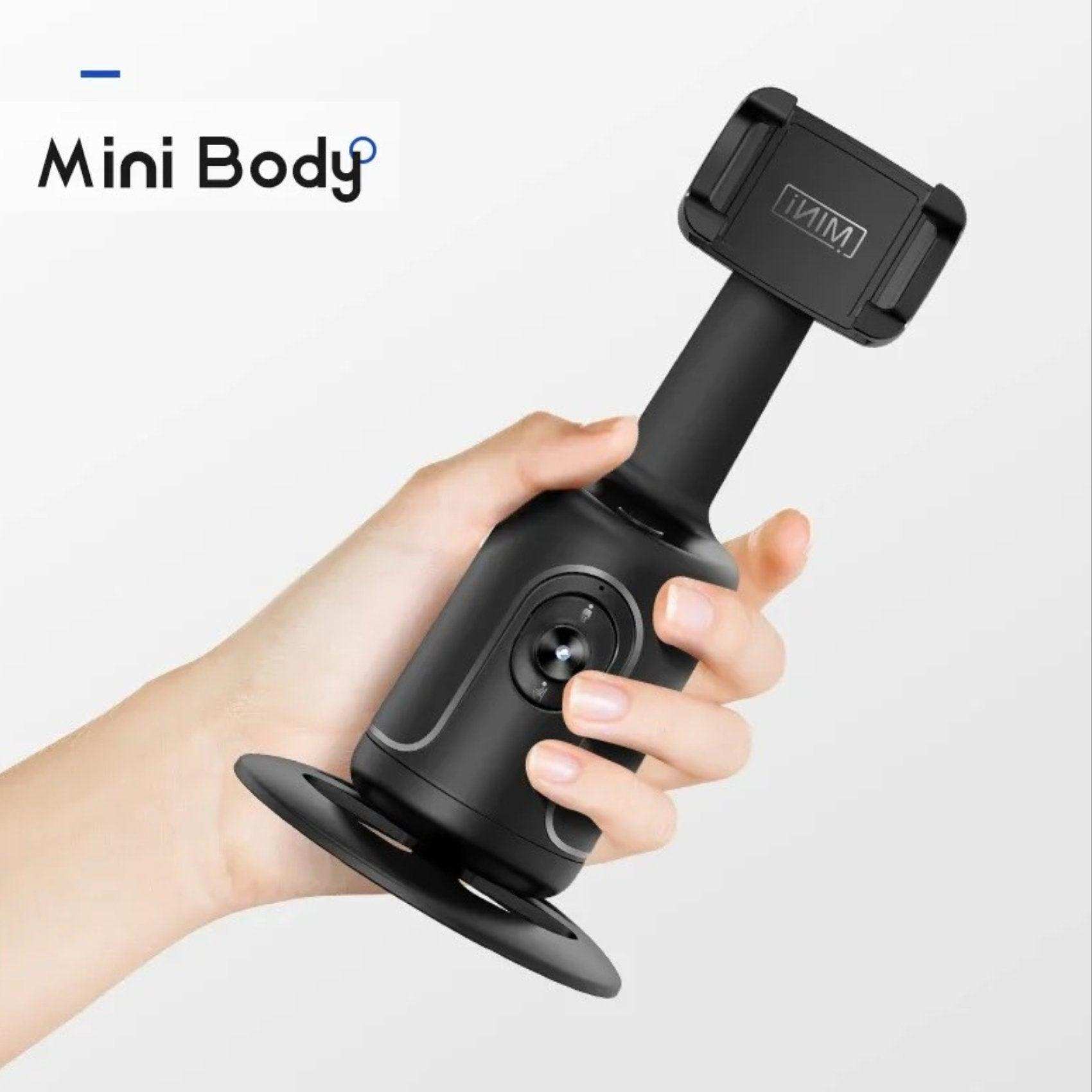 Hand holding a mini body black 360° selfie phone holder with face tracking gimbal TUTT