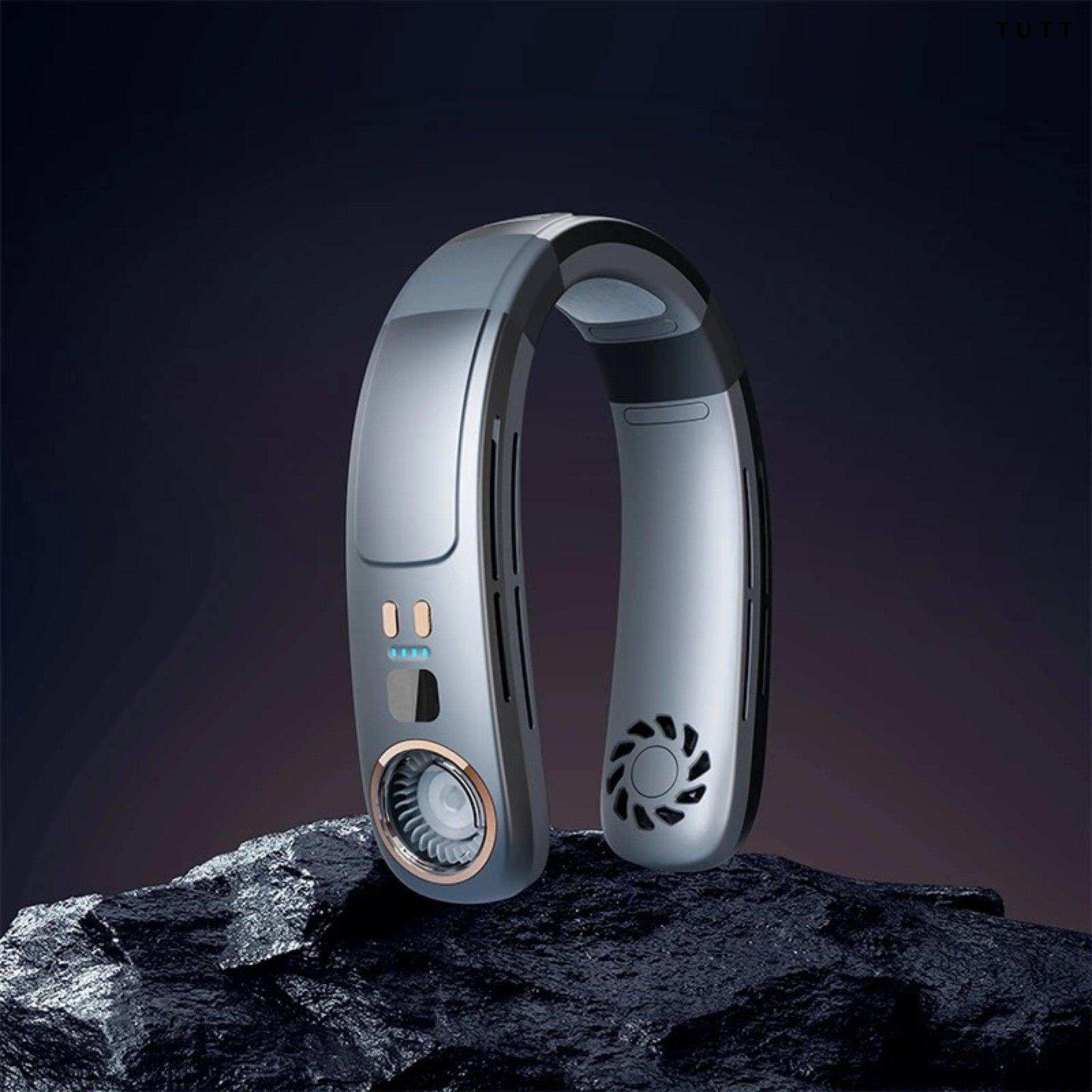 Bladeless portable neck cooling fan with vents and control panel on a dark rock, TUTT