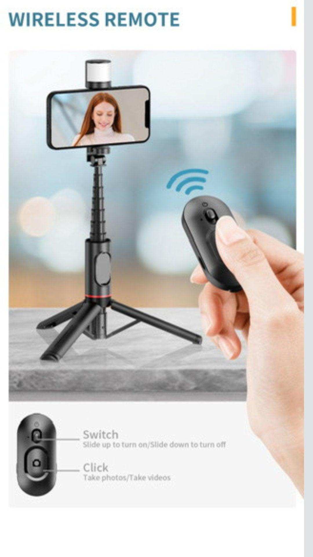Selfie stick phone holder with fill light, wireless remote, and tripod on table, TUTT