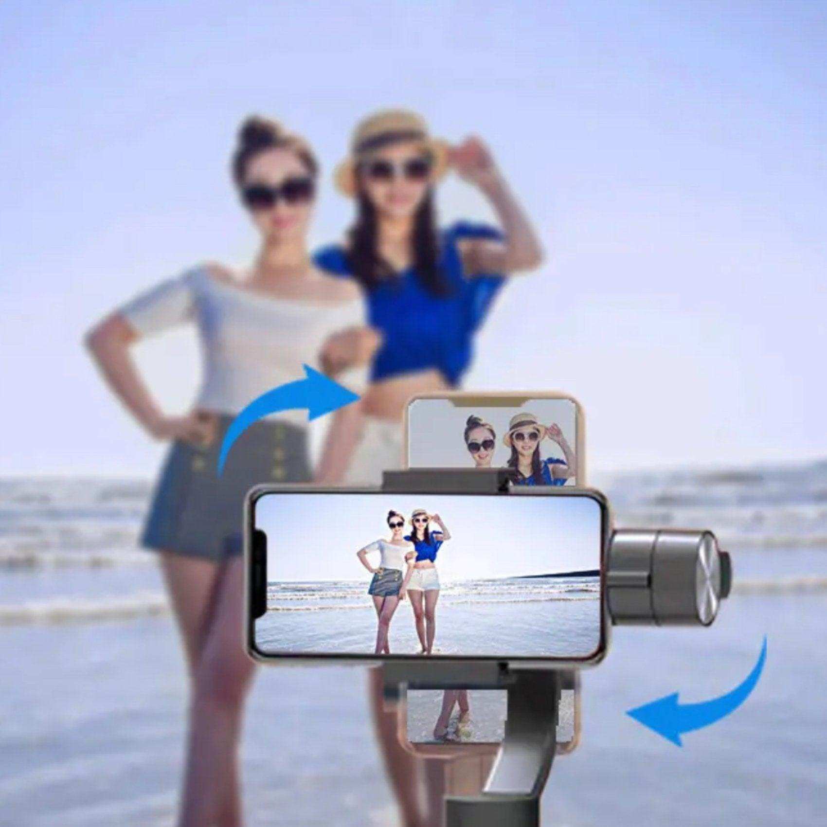 Smartphone on 3-axis gimbal stabilizer tripod taking selfie of two women at beach, TUTT