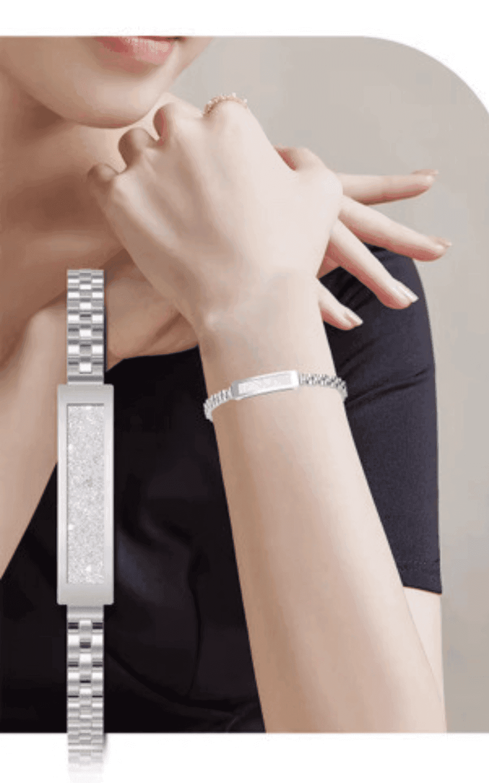 Woman wearing a silver smart fitness bracelet with crystal detail, elegant design, TUTT