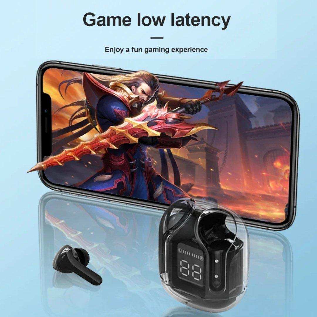 Black true wireless earbuds with digital display case in front of smartphone showing a game, TUTT