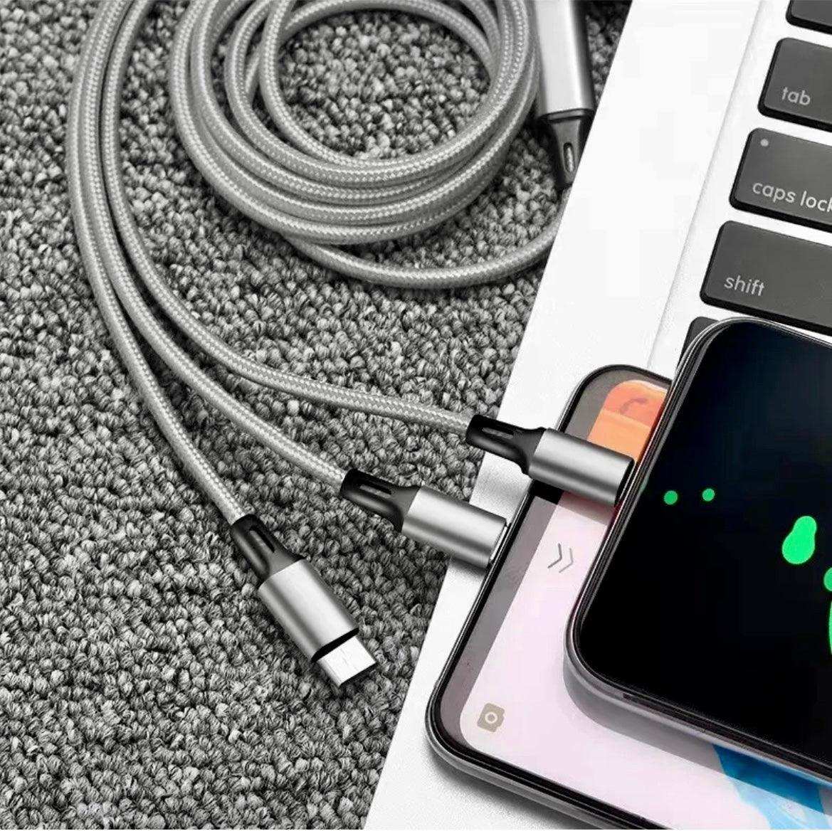 3-in-1 charging cable plugged into smartphone and laptop on grey carpet, travel tech kit TUTT