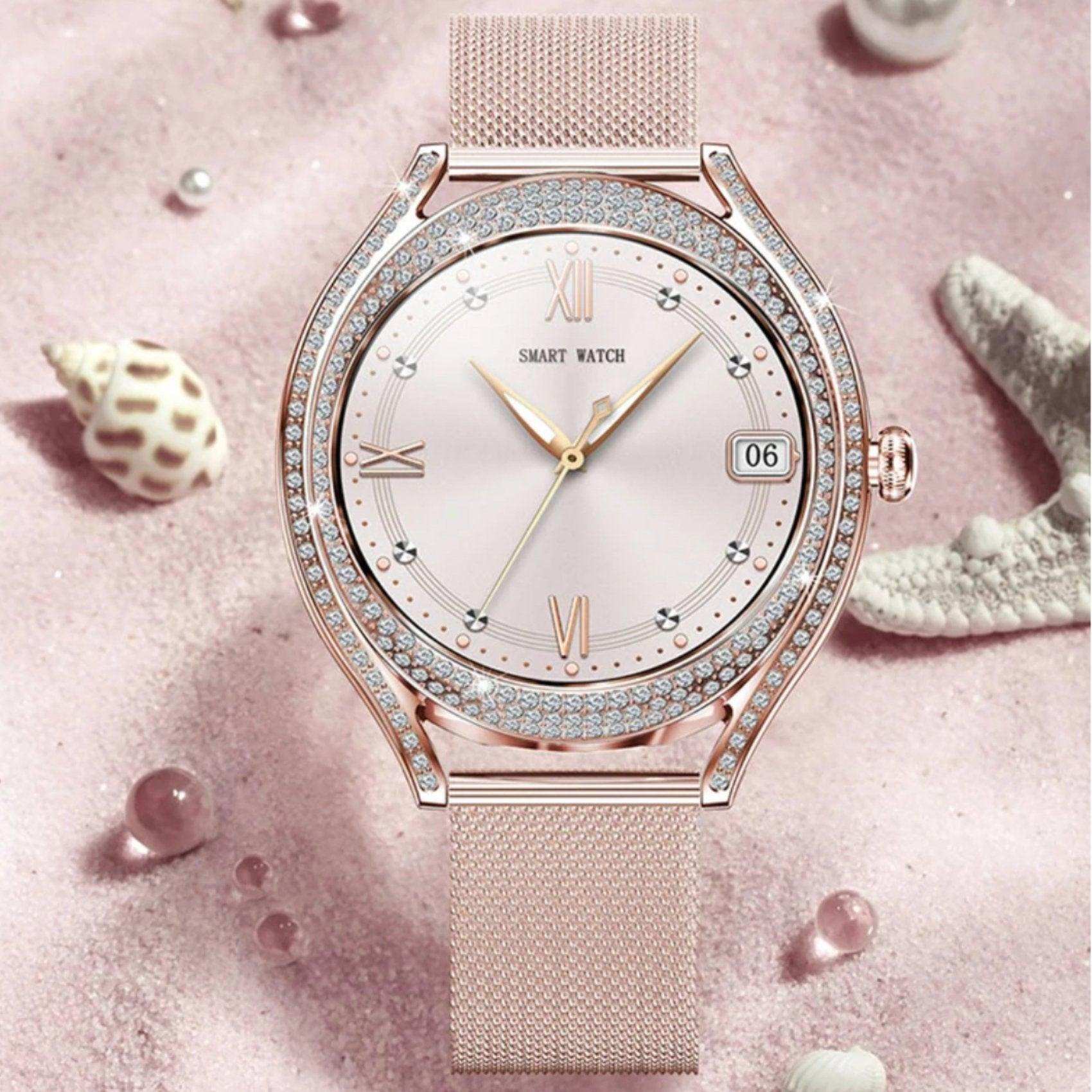 Rose gold ladies smart watch with crystal bezel on pink sand, seashells and starfish. TUTT