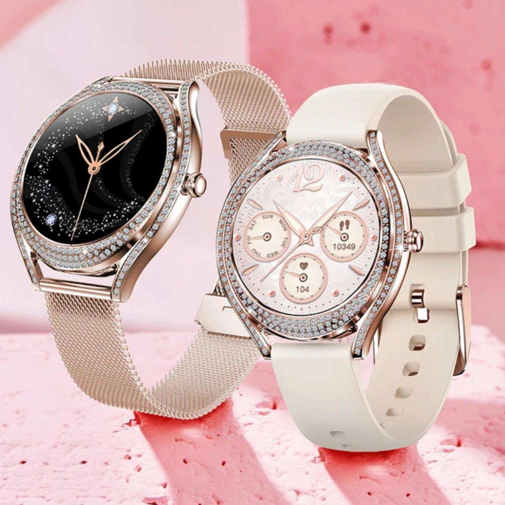Elegant ladies smartwatches with crystal bezels, mesh and silicone straps, on pink backdrop, TUTT