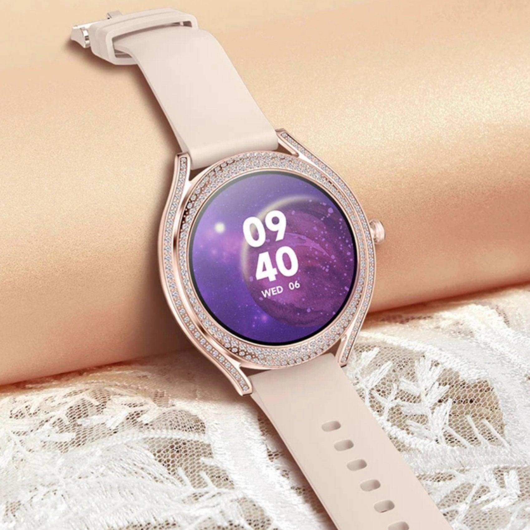 Rose gold ladies smartwatch with zirconia bezel and pink strap displayed on lace fabric, TUTT
