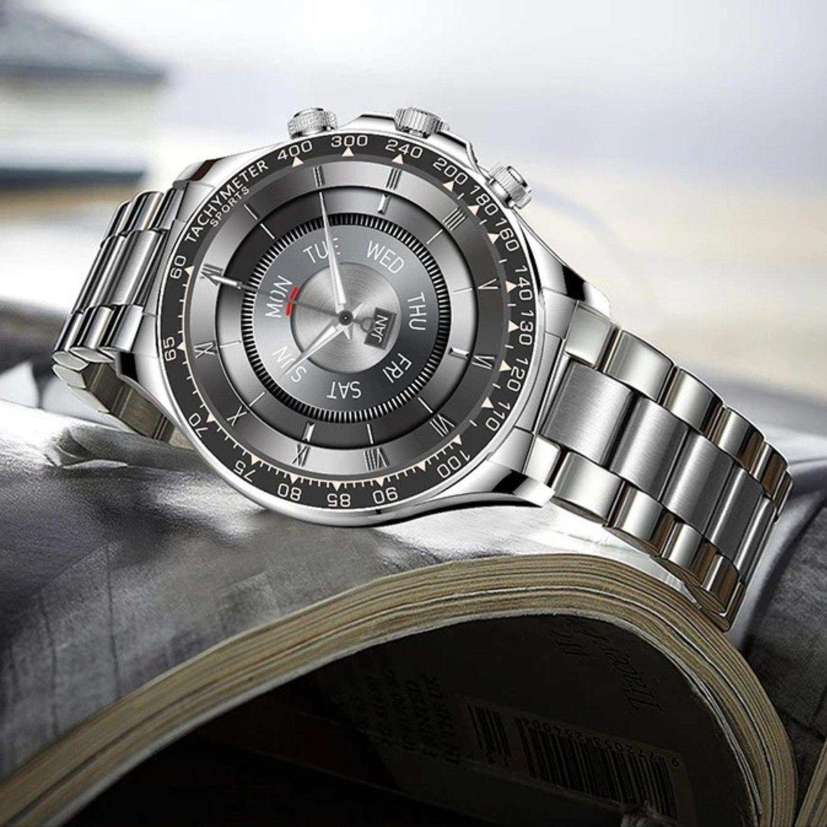 Stainless steel rugged military smartwatch with tachymeter bezel on open book, TUTT